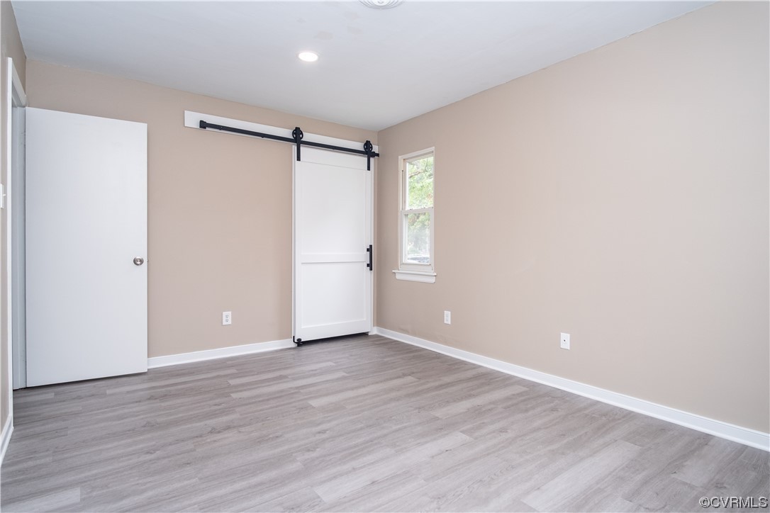 2307 Crosscreek Road Richmond, VA 23223 - Photo 8 of 14 a view of an empty room with wooden floor and a window