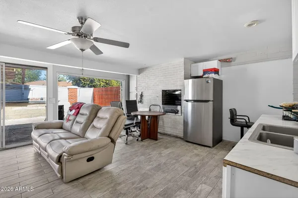 a living room with furniture and kitchen view