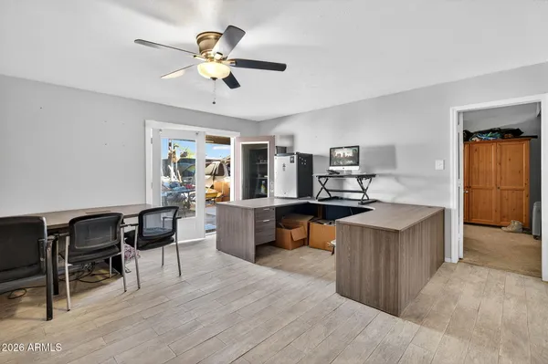 a living room with furniture kitchen view and a large window
