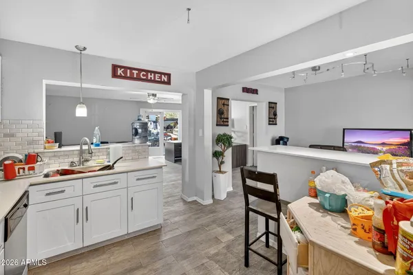 a kitchen with a refrigerator and white cabinets