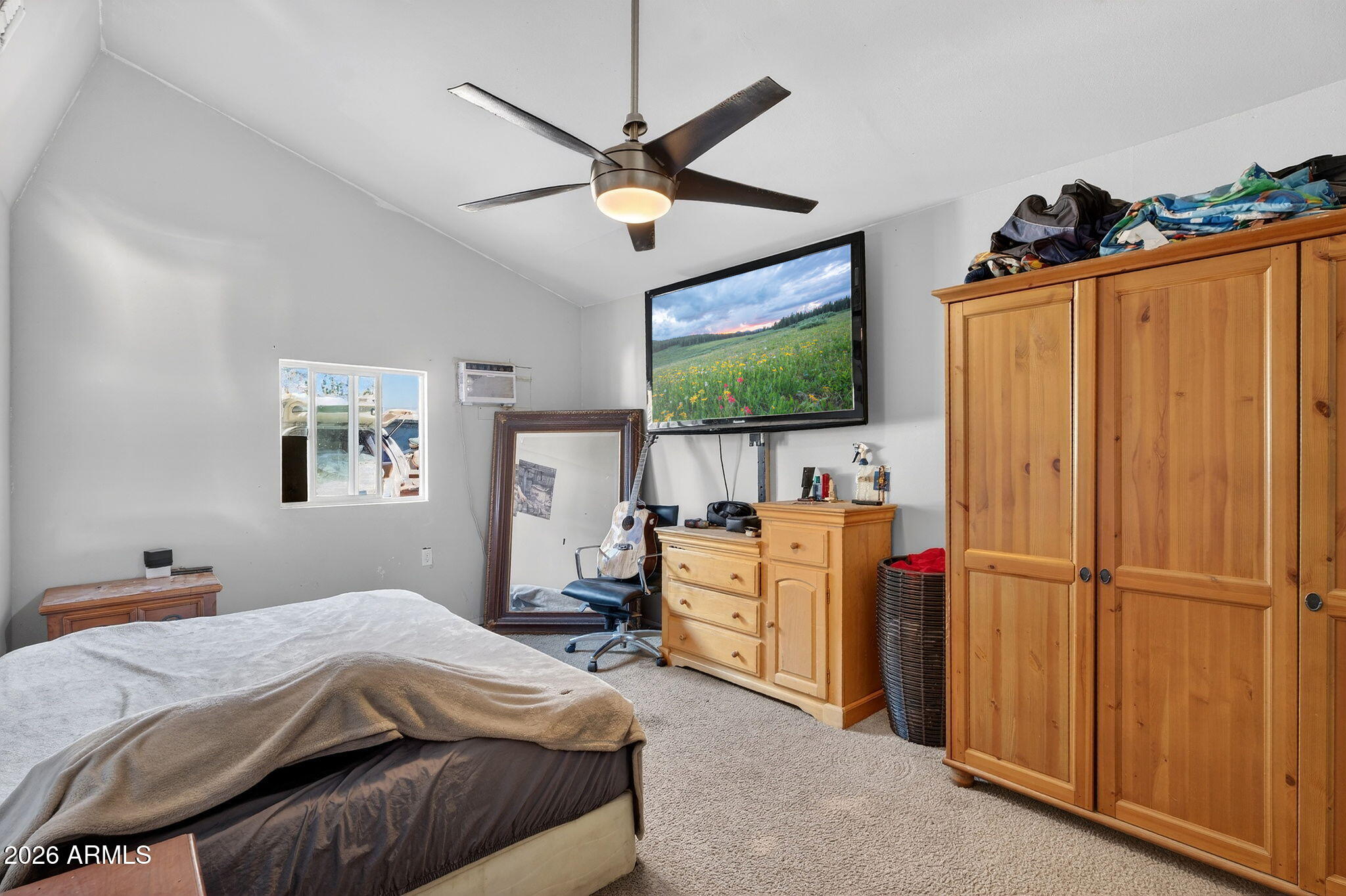 2222 West Flower Street Phoenix, AZ 85015 - Photo 19 of 36 a bedroom with a bed and a flat screen tv