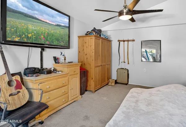 a bedroom with a bed and a flat screen tv