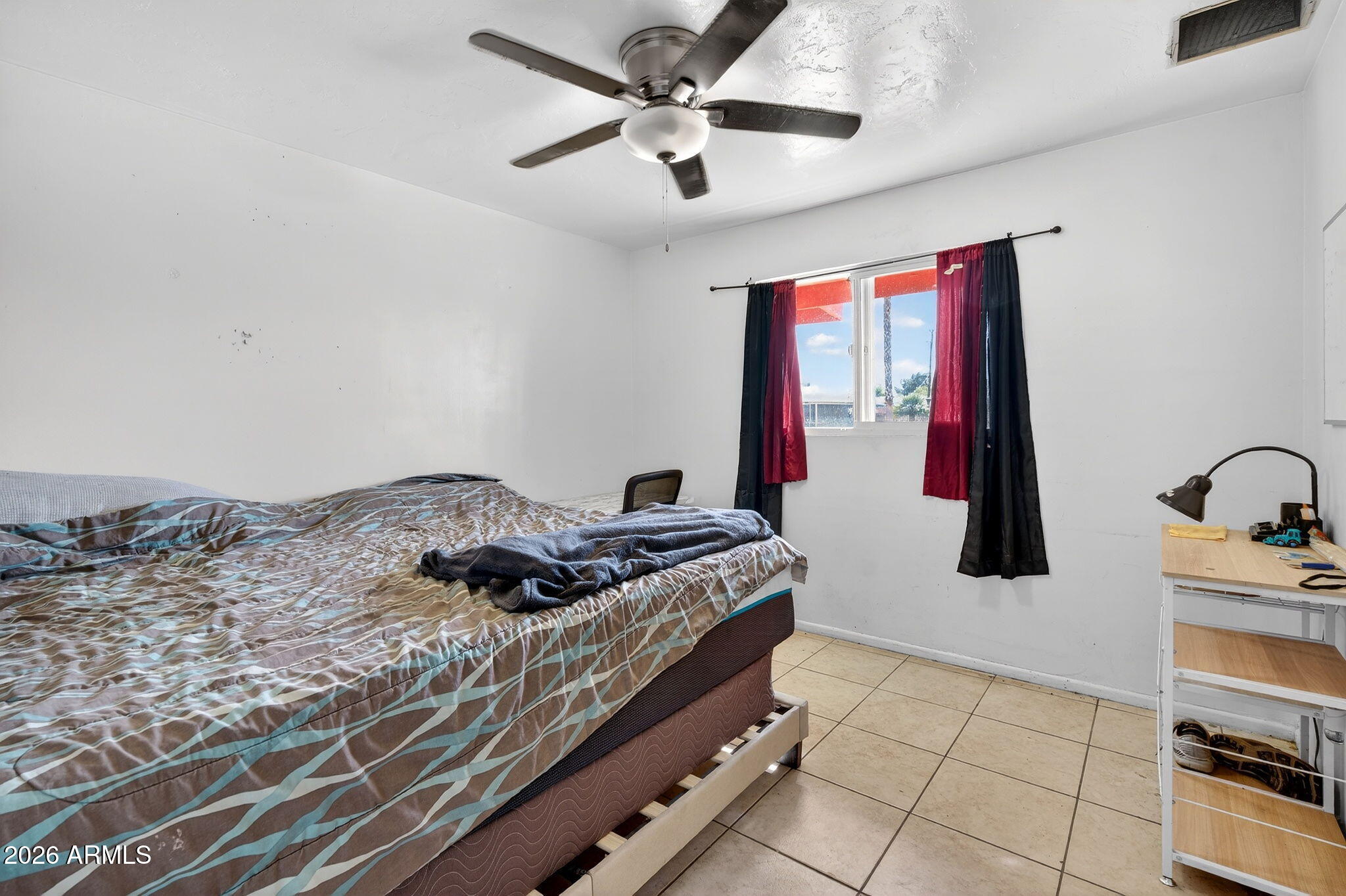 2222 West Flower Street Phoenix, AZ 85015 - Photo 25 of 36 a bed sitting in a bedroom next to a window