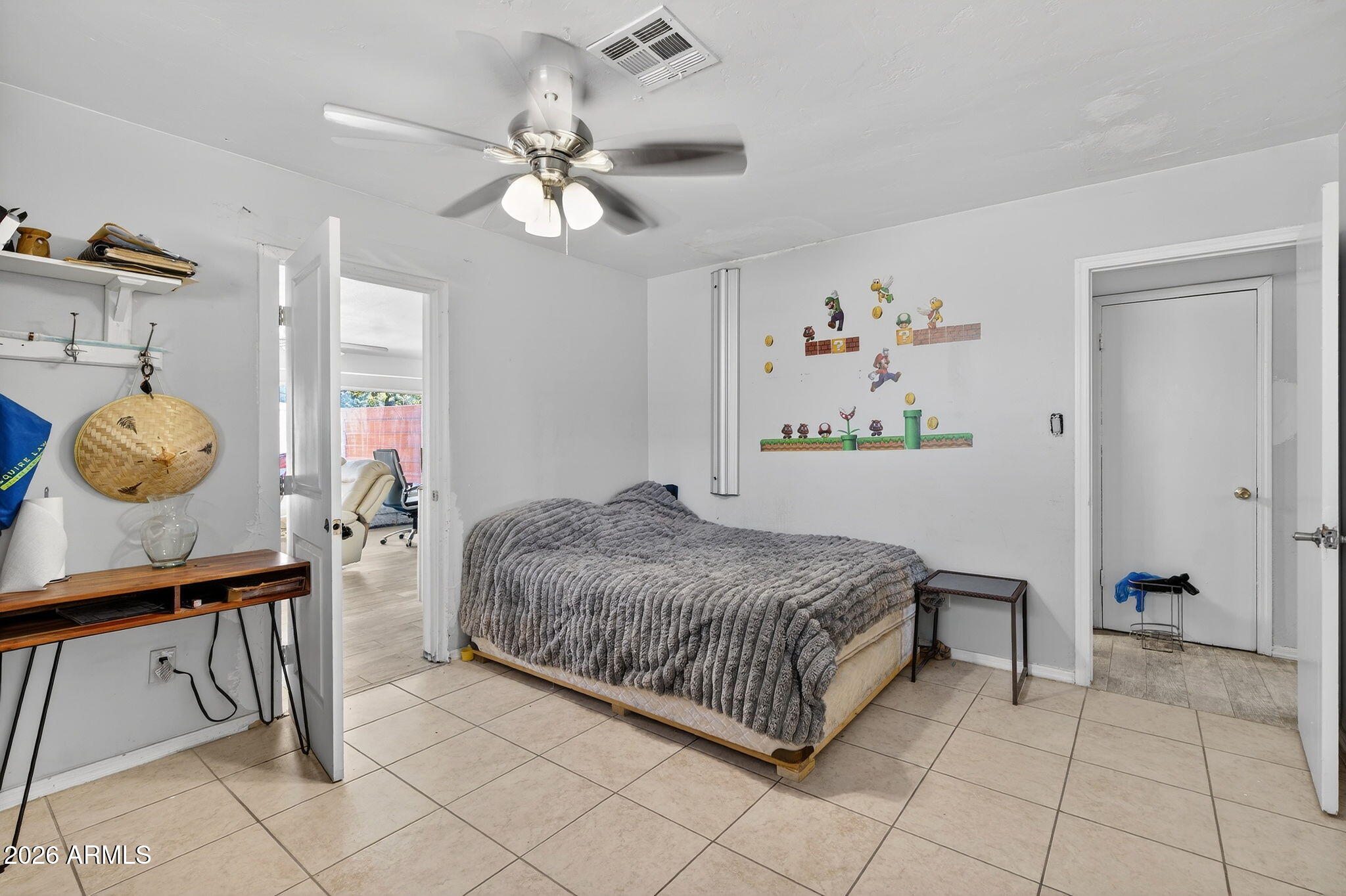 2222 West Flower Street Phoenix, AZ 85015 - Photo 27 of 36 a bedroom with a bed and a chandelier