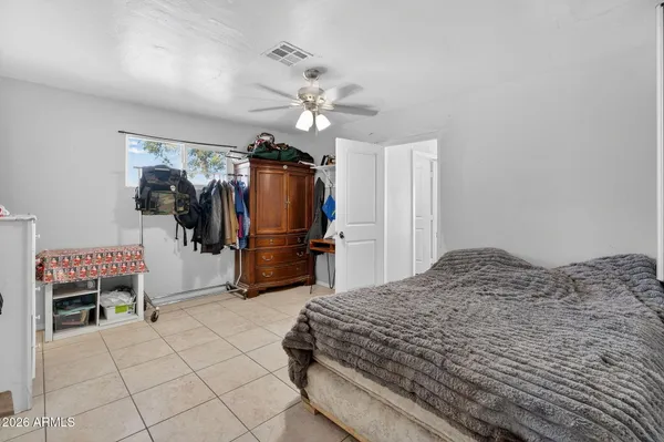 a bedroom with a bed and a television