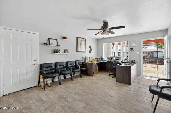 a living room with furniture and wooden floor