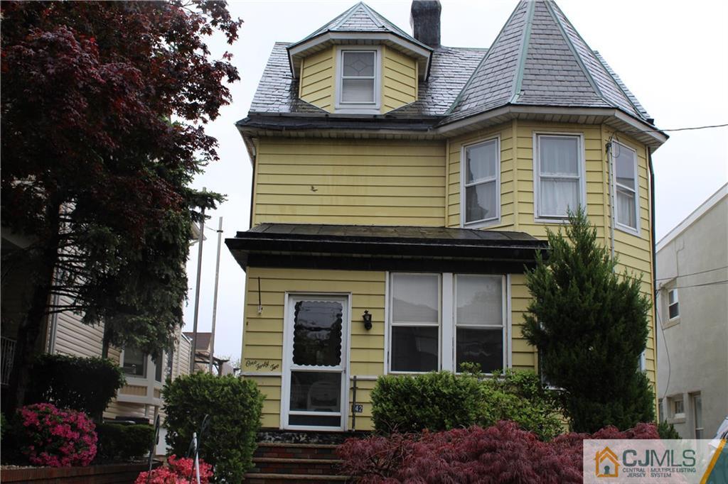 142 Rector Street Perth Amboy, NJ 08861 - Photo 1 of 22 a front view of a house with a garden