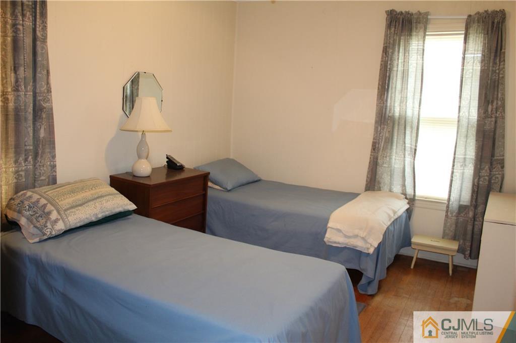 142 Rector Street Perth Amboy, NJ 08861 - Photo 12 of 22 a bedroom with a bed and a window