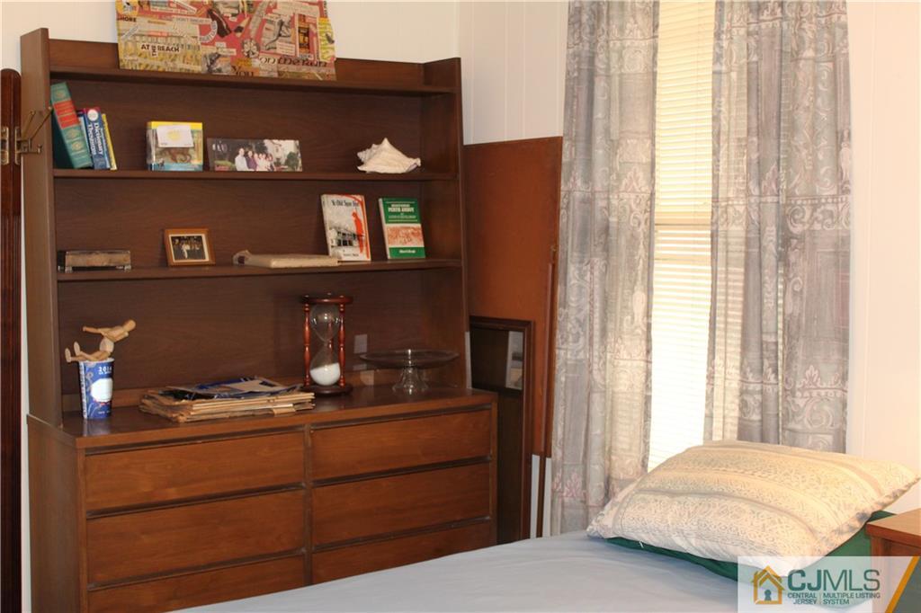 142 Rector Street Perth Amboy, NJ 08861 - Photo 13 of 22 a bedroom with a bed and wooden floor