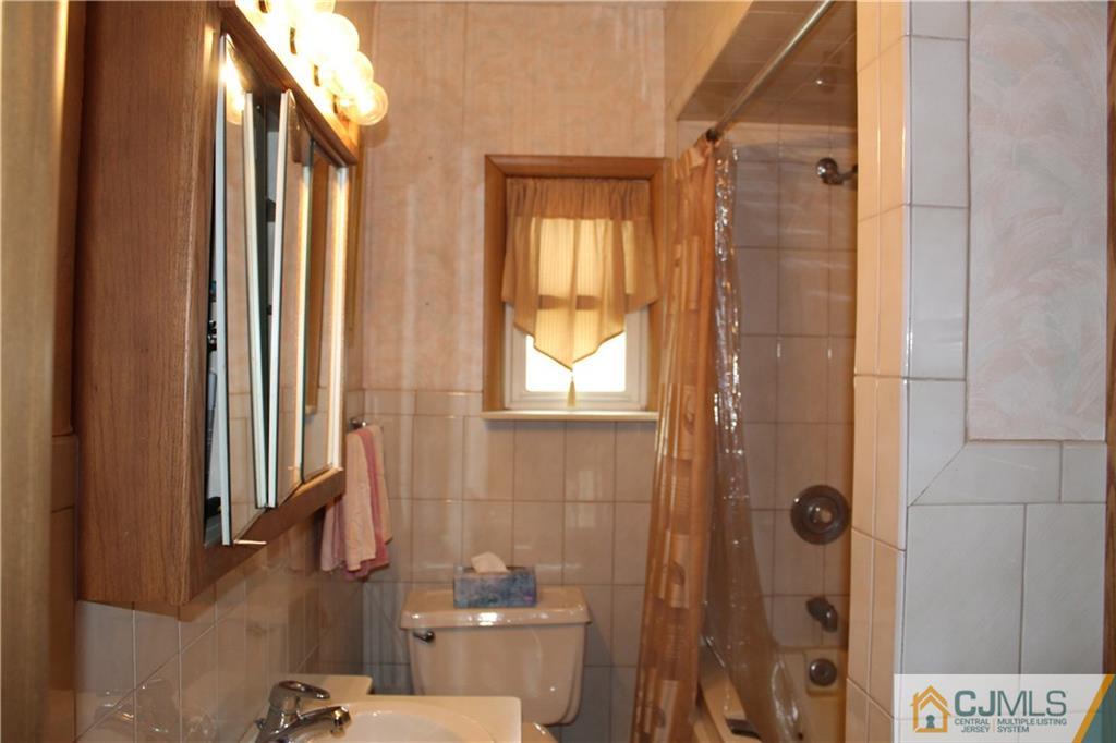 142 Rector Street Perth Amboy, NJ 08861 - Photo 15 of 22 a bathroom with a shower and a toilet