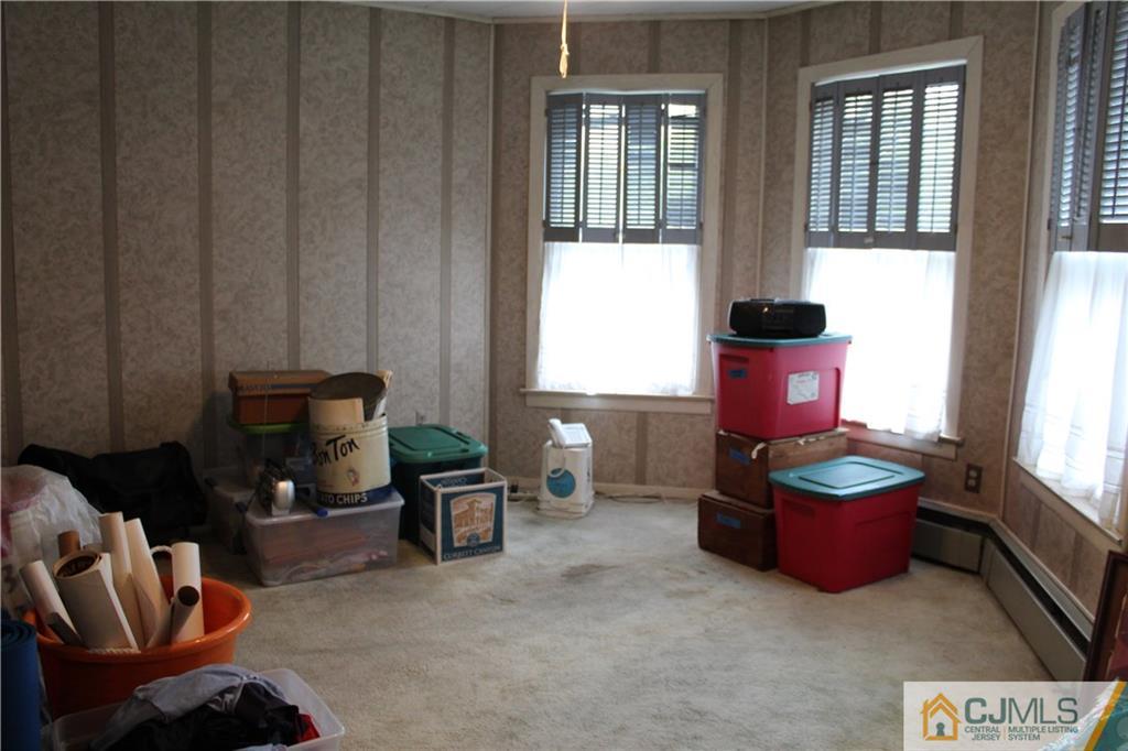 142 Rector Street Perth Amboy, NJ 08861 - Photo 16 of 22 a living room with furniture and a potted plant
