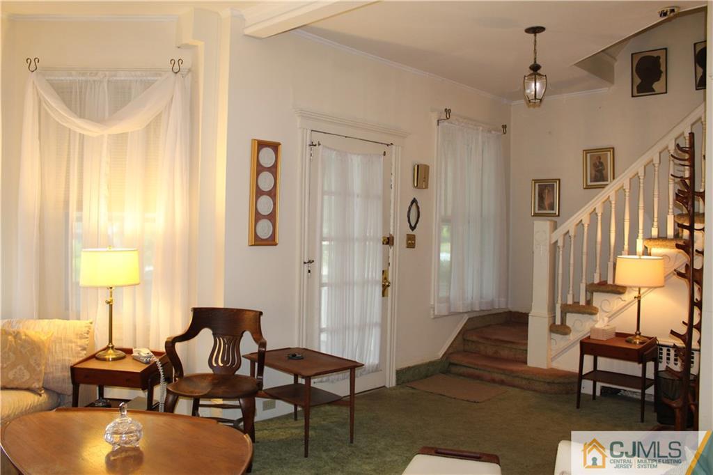142 Rector Street Perth Amboy, NJ 08861 - Photo 3 of 22 a living room with furniture and a chandelier