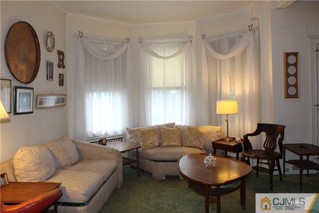 142 Rector Street Perth Amboy, NJ 08861 - Photo 4 of 22 a living room with furniture a mirror and a window