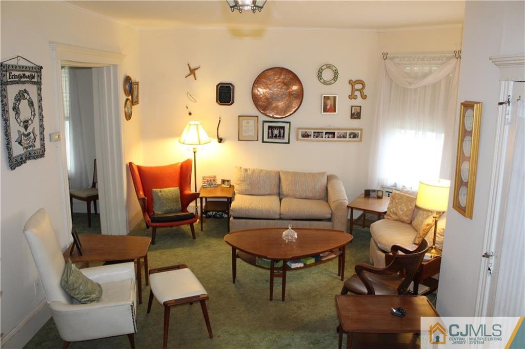 142 Rector Street Perth Amboy, NJ 08861 - Photo 5 of 22 a living room with furniture and a wall painting
