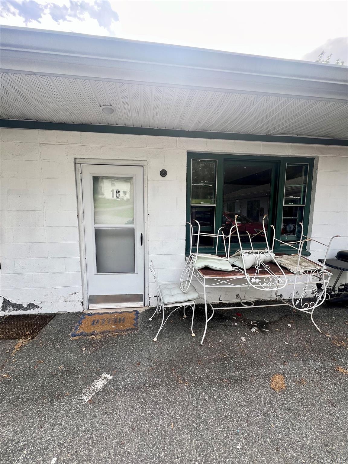 1612-1616 Rte 9W, Unit 18 Milton, NY 12547 - Photo 1 of 6 a backyard of a house with outdoor seating