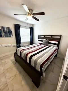 a bedroom with a bed and window