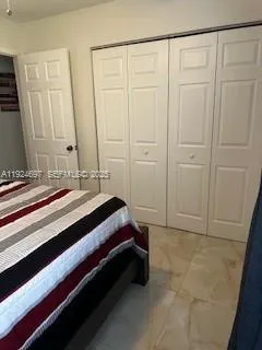 a spacious bedroom with a bed and a shower