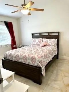 a bed sitting in a bedroom next to a window