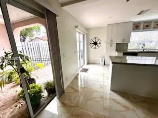 a kitchen with stainless steel appliances kitchen island granite countertop a refrigerator sink and stove