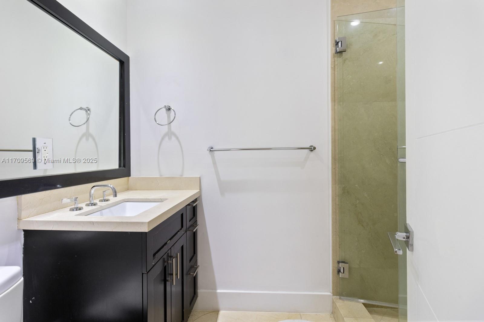 140 West Mashta Drive Key Biscayne, FL 33149 - Photo 11 of 35 a bathroom with a sink and a mirror
