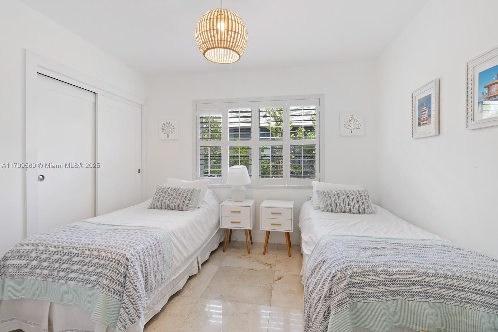 140 West Mashta Drive Key Biscayne, FL 33149 - Photo 12 of 35 a bedroom with a bed and a large window