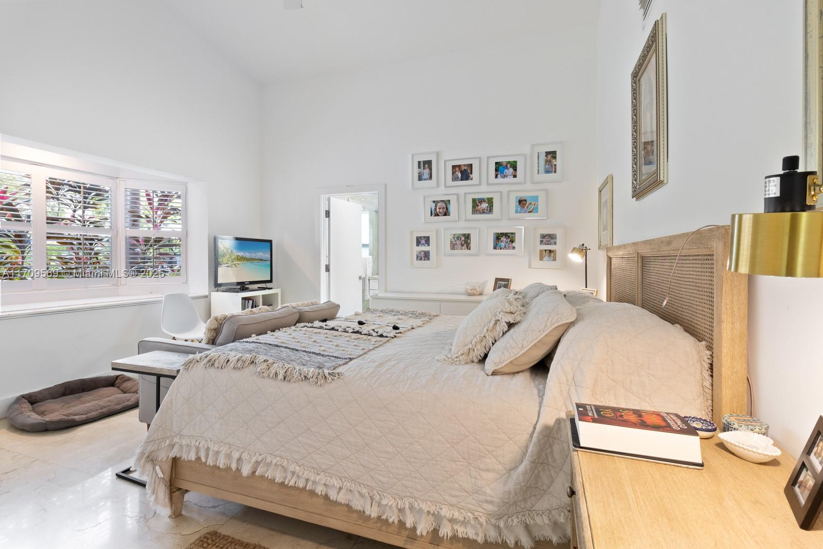 140 West Mashta Drive Key Biscayne, FL 33149 - Photo 15 of 35 a bedroom with a bed and a window