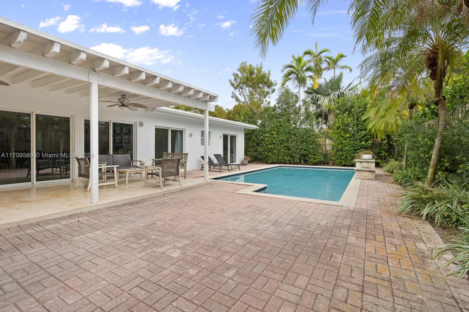 140 West Mashta Drive Key Biscayne, FL 33149 - Photo 21 of 35 a view of a house with a swimming pool and sitting area