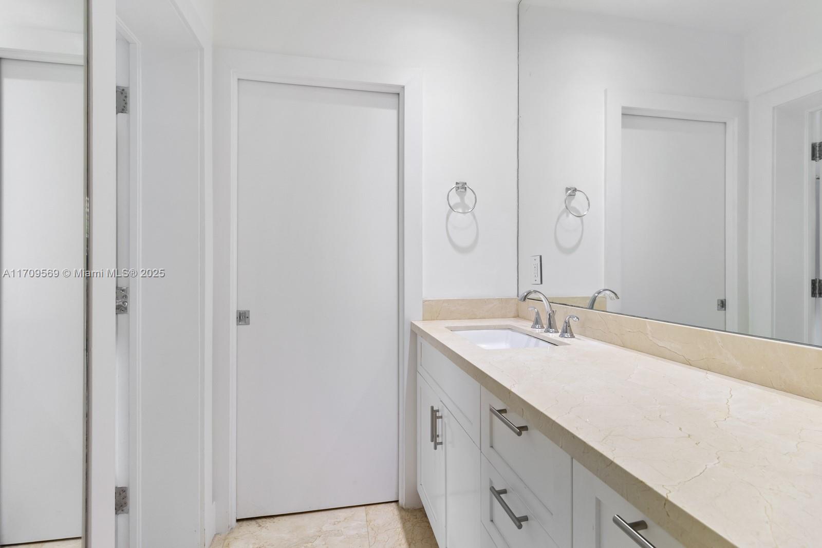 140 West Mashta Drive Key Biscayne, FL 33149 - Photo 23 of 35 a bathroom with a sink and a mirror