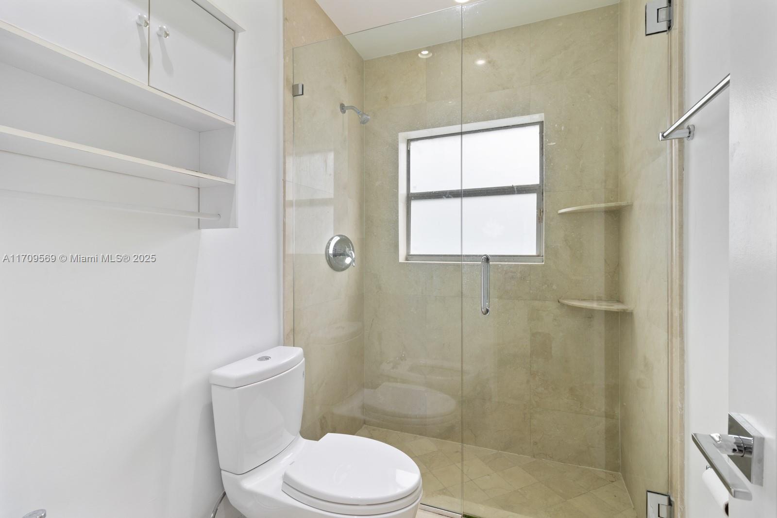 140 West Mashta Drive Key Biscayne, FL 33149 - Photo 24 of 35 a white toilet sitting next to a bathroom sink