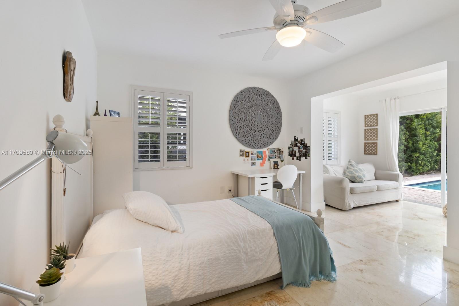 140 West Mashta Drive Key Biscayne, FL 33149 - Photo 25 of 35 a bedroom with a bed couch and window