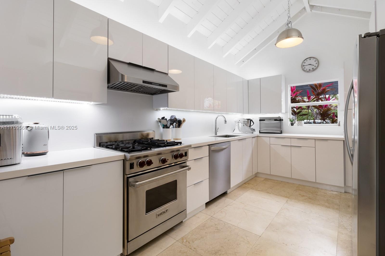 140 West Mashta Drive Key Biscayne, FL 33149 - Photo 29 of 35 a kitchen with a stove and a sink