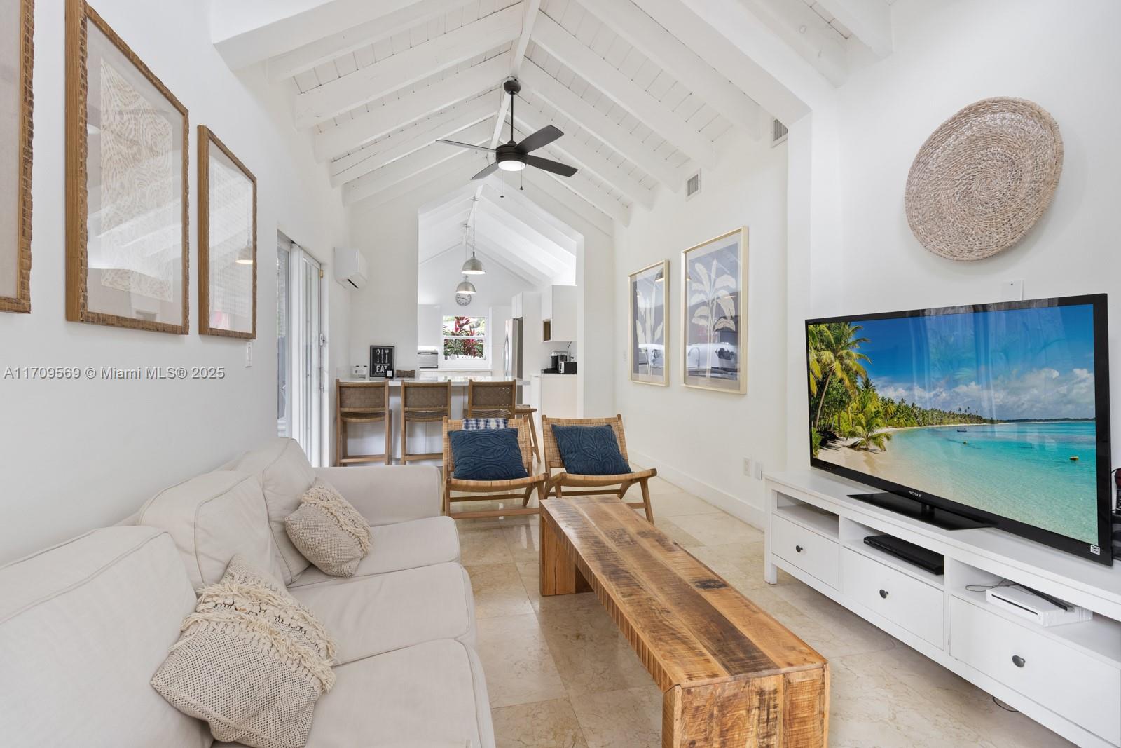 140 West Mashta Drive Key Biscayne, FL 33149 - Photo 34 of 35 a living room with furniture and a flat screen tv