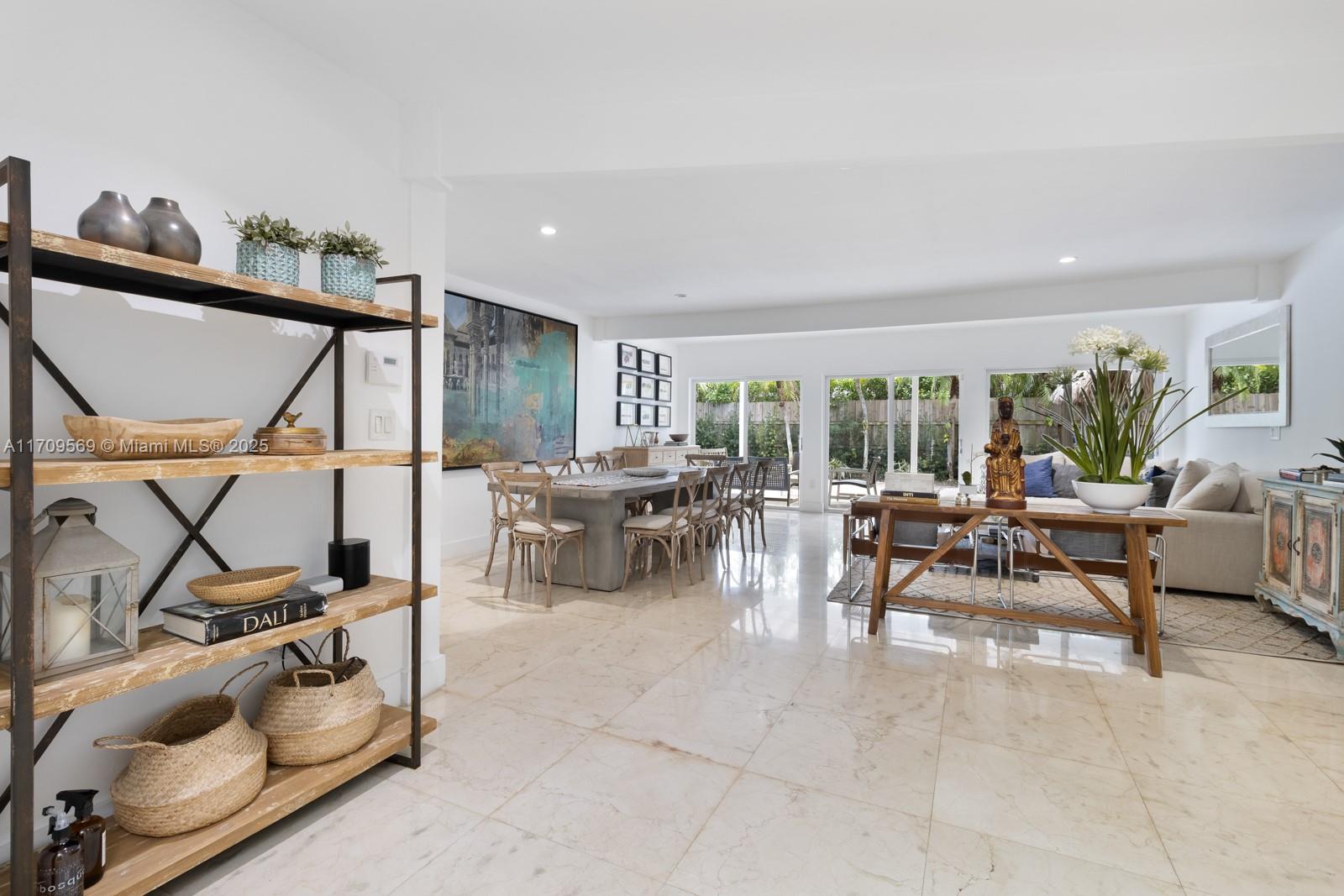 140 West Mashta Drive Key Biscayne, FL 33149 - Photo 4 of 35 a living room with furniture a air conditioner and a table