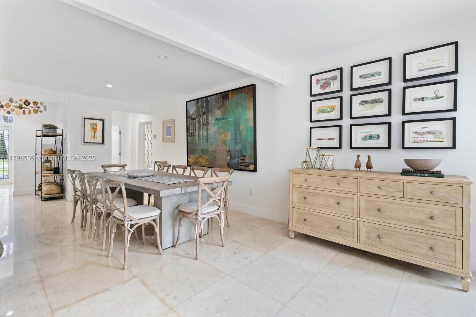 140 West Mashta Drive Key Biscayne, FL 33149 - Photo 7 of 35 a dining room with a wooden table and chairs