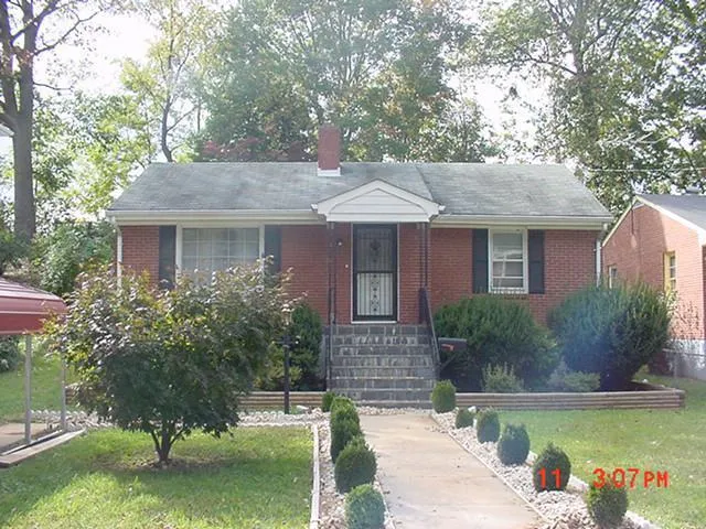 a front view of a house with a yard garage and outdoor seating
