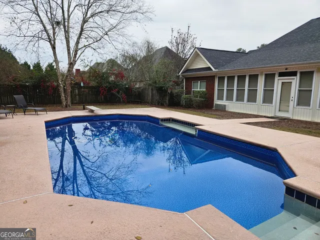 a view of pool with outdoor seating