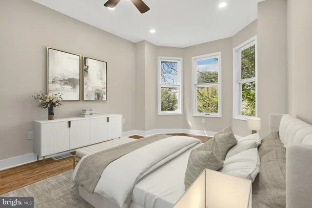 a spacious bedroom with a bed and a large window