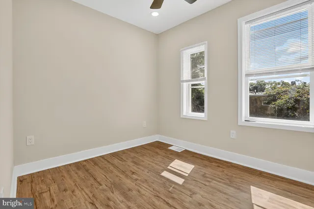 a view of a room with wooden floor and windows