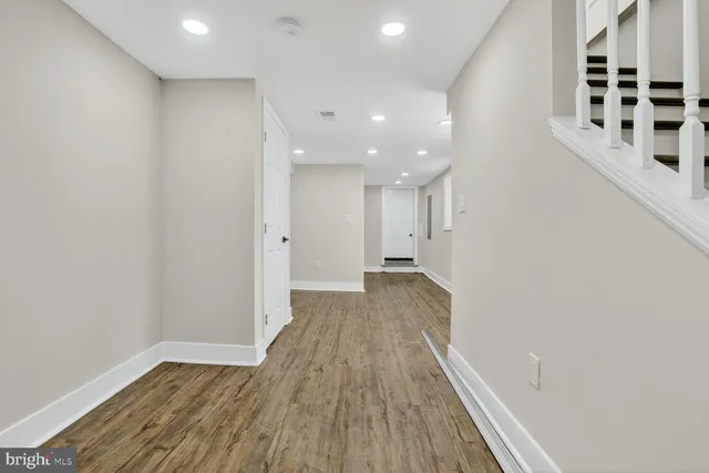a view of a hallway with wooden floor