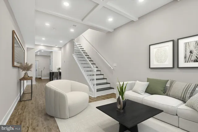 a living room with furniture and a dining table with wooden floor