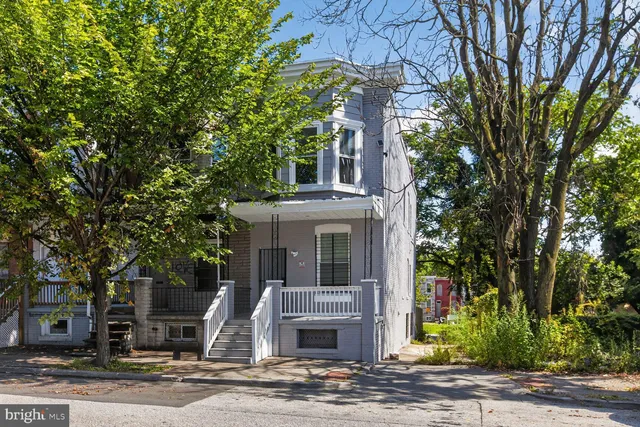 front view of a house with a tree
