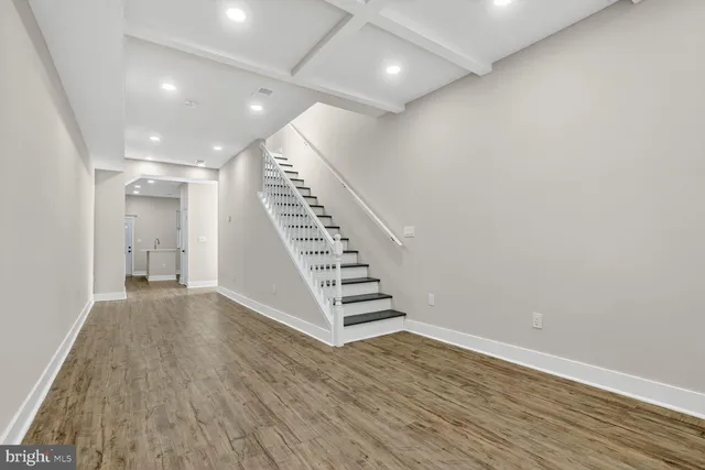 an empty room with wooden floor