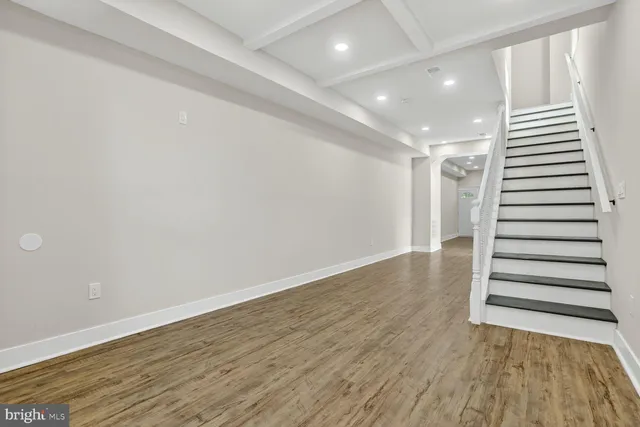 a view of a room with wooden floor