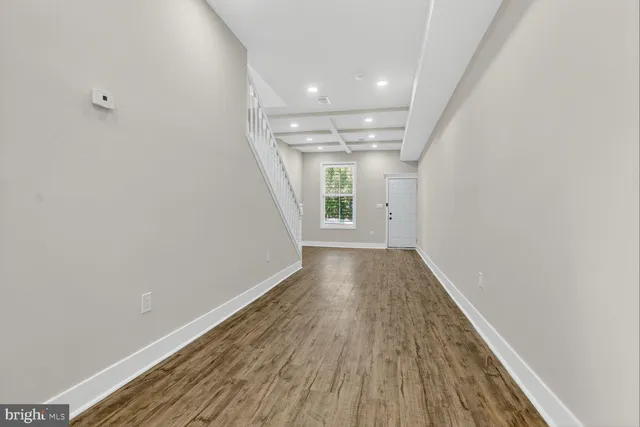 a view of a room with wooden floor