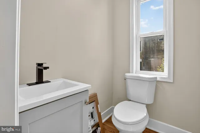a bathroom with a toilet sink and window