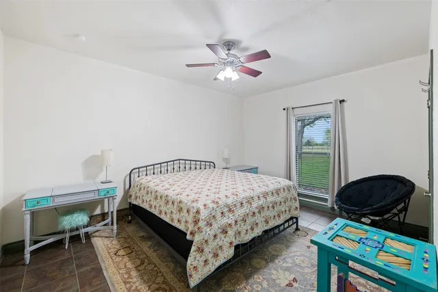 a bedroom with a bed a dresser and a window