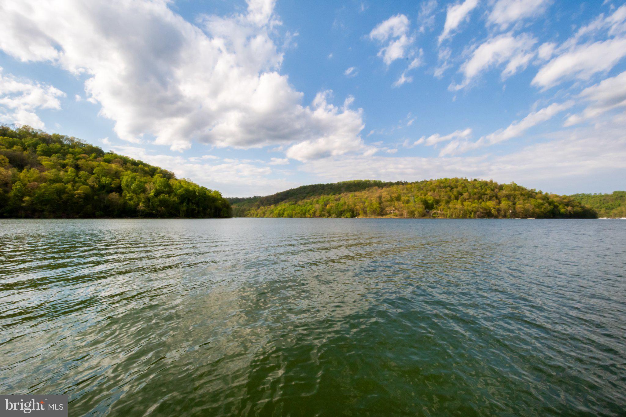 750 Lake Side Road Addison, PA 15411 - Photo 11 of 51 Serene waters reflect vibrant hills.