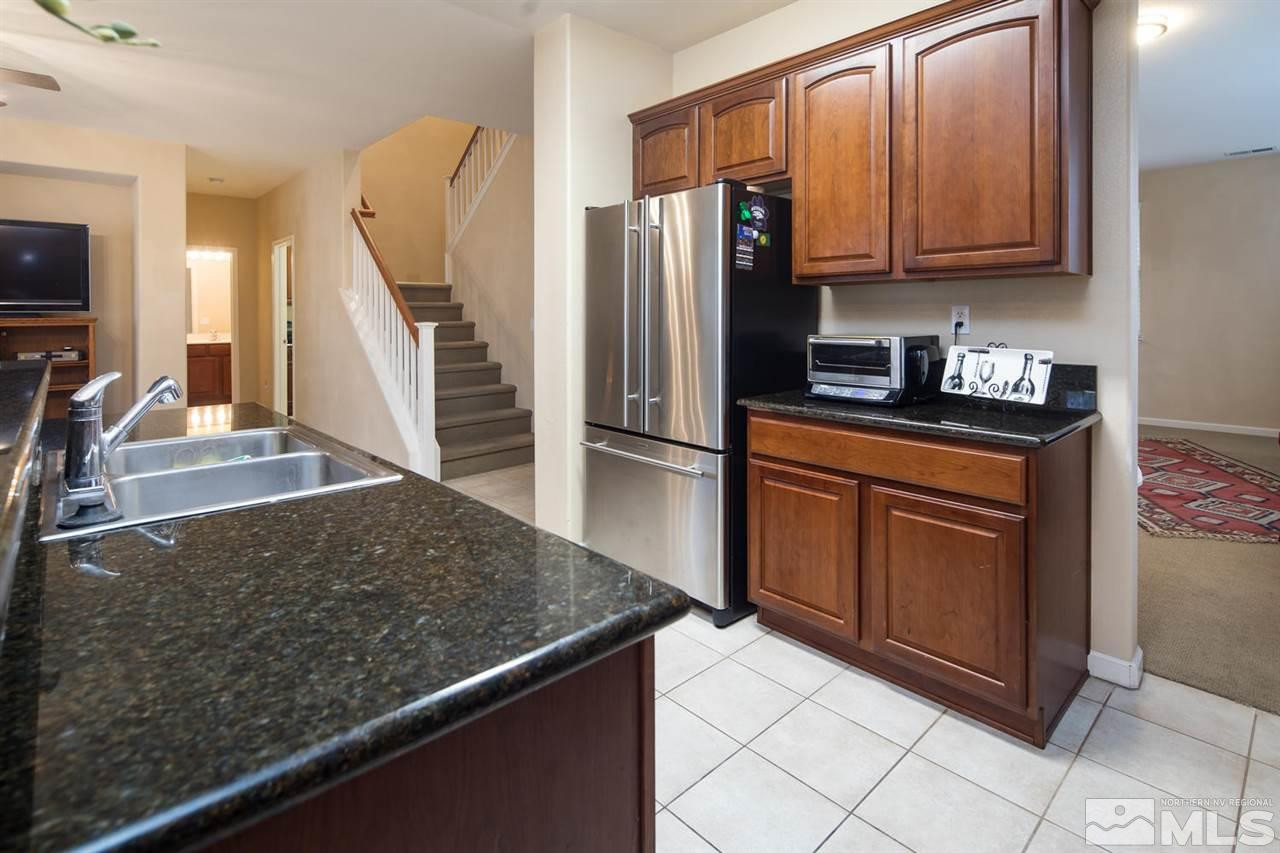 856 North University Park Loop Reno, NV 89512 - Photo 10 of 22 a kitchen with stainless steel appliances granite countertop a refrigerator a stove and a sink
