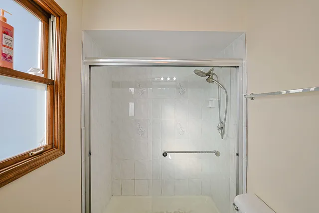 a bathroom with a glass shower door
