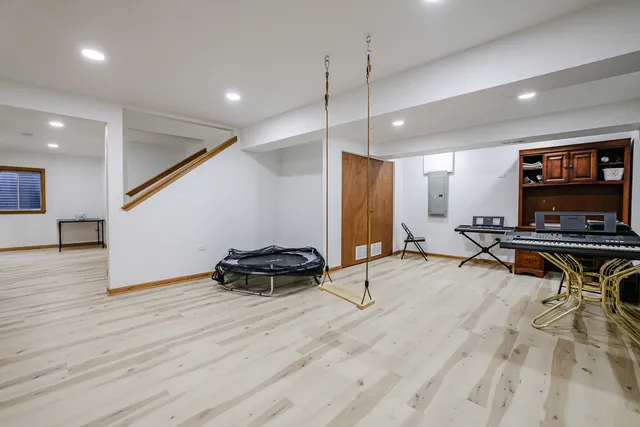 a room with wooden floor and furniture